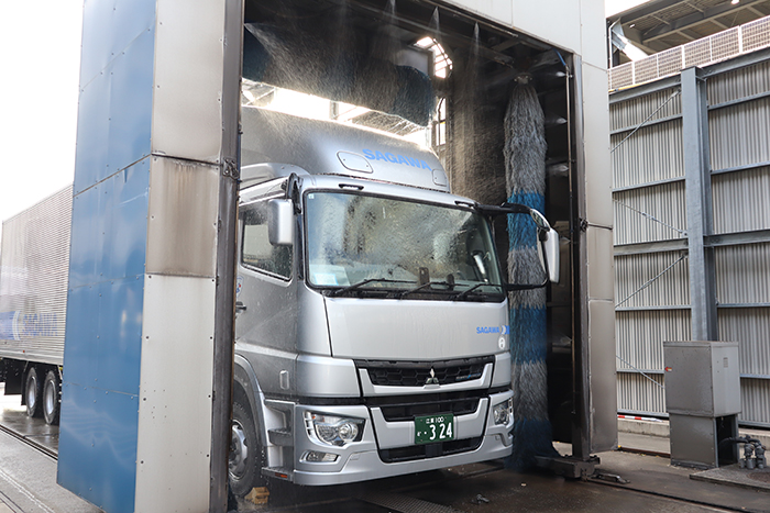 平日15時、その日の運行を終えた大型トラックのドライバーが洗車場へ。大型トラックの場合は洗車機を使ってきれいに洗車することもあります。迫力があってかっこいいですね。相棒をきれいにして本日の業務は終了。